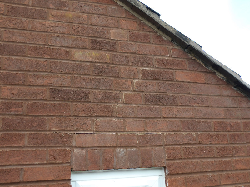 A filled stepped crack above a doorway